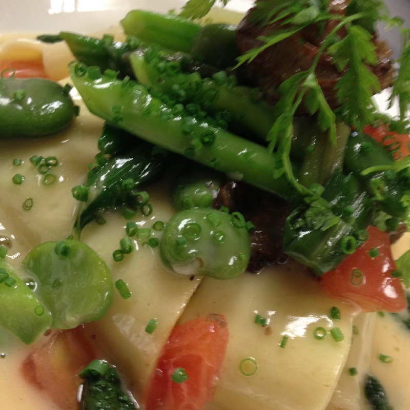 Ricotta raviolo with spring vegetable fondue